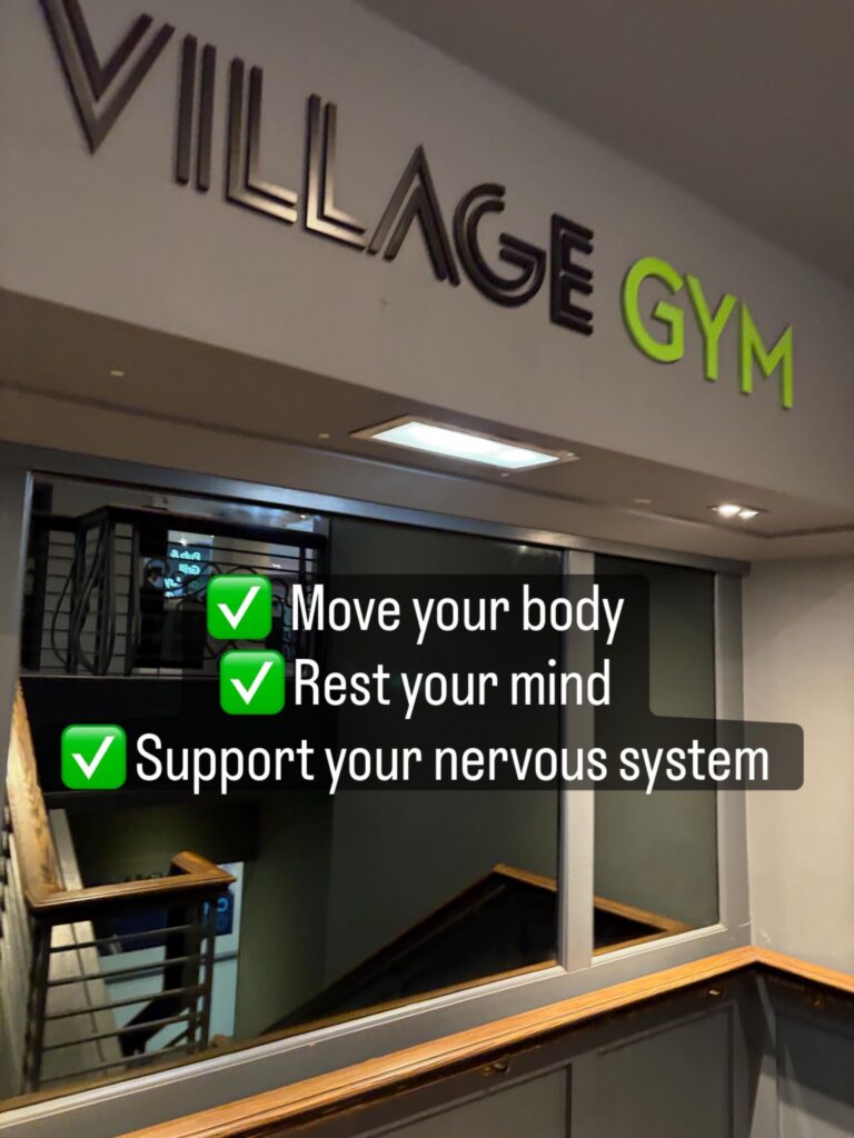 Interior of Village Gym Warrington with text overlay reading “Move your body, Rest your mind, Support your nervous system” alongside a blog post about self-care as maintenance and reflexology in Lymm.