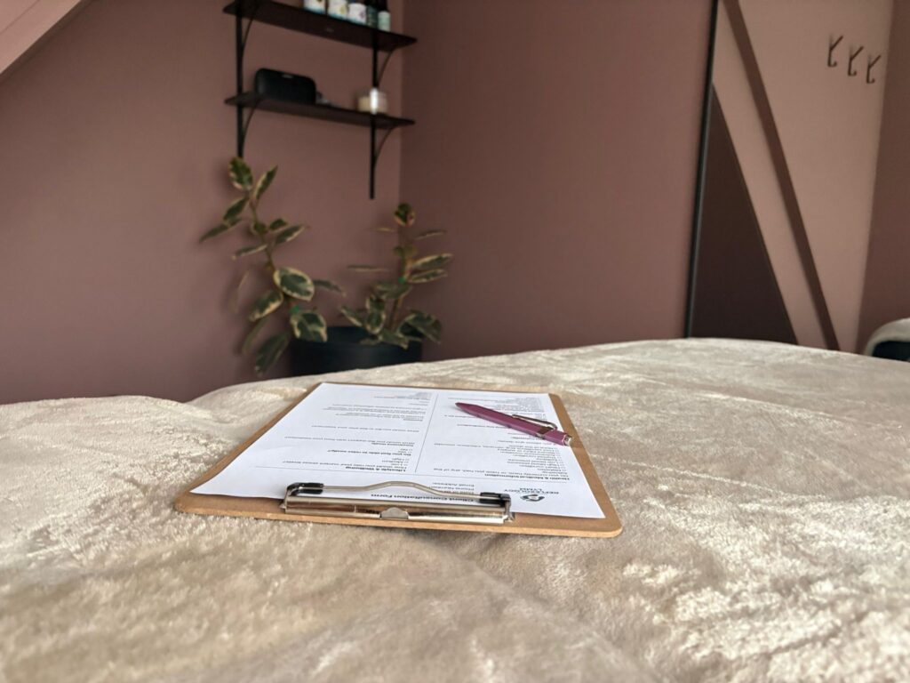 Qualified reflexologist carrying out a client consultation before treatment in Lymm